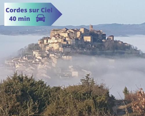 a village on a hill in the middle of the water at Entre rivière & bambous - Vue rivière - Parc arboré - Petfriendly in Saint-Juéry