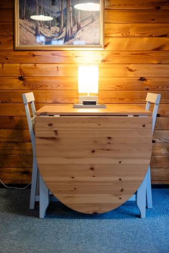 a desk with a lamp and two chairs in a room at Cozy Norwegian Style Log Cabin in Rural Snowdonia - 2 Bedrooms & Parking by Seren Short Stays in Ffestiniog