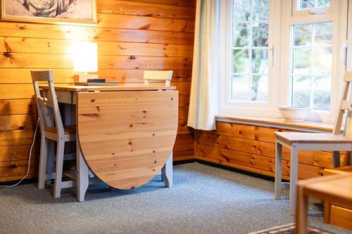 a desk in a room with a wooden wall at Cozy Norwegian Style Log Cabin in Rural Snowdonia - 2 Bedrooms & Parking by Seren Short Stays in Ffestiniog