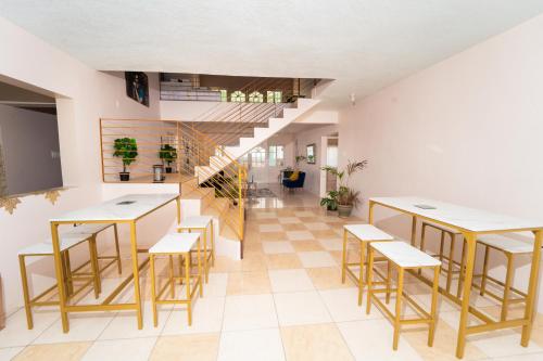 a room with tables and chairs and a staircase at Bell Air Seaview (3 BDRM 3 BATH) in Runaway Bay