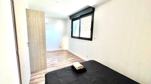 a bedroom with a bed with a book on it at Les Gîtes de la Chapelle 4 in Vauvert
