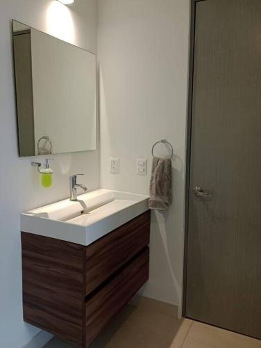 a bathroom with a sink and a mirror at Federalta Aptm 1 parking/2BR/2BA in Guadalajara