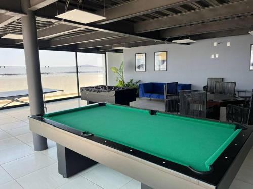 a pool table in a room with a view of the beach at Federalta Aptm 1 parking/2BR/2BA in Guadalajara