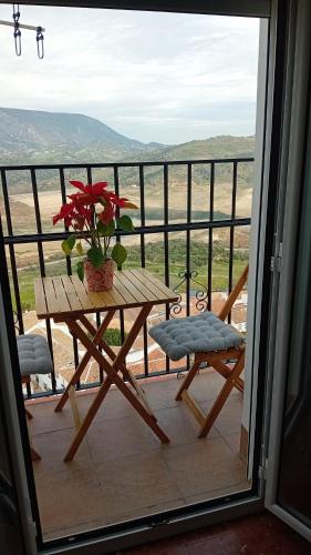 a table with a potted plant on a balcony at Casa Rural Plaza Zahara Buenas Vistas in Zahara de la Sierra