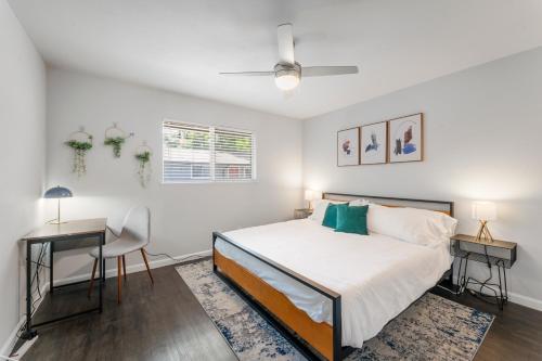 a white bedroom with a bed and a desk at Prime SoLa Chic 1BR King Bed Suites with Laundry, Desk, Kitchen in Austin