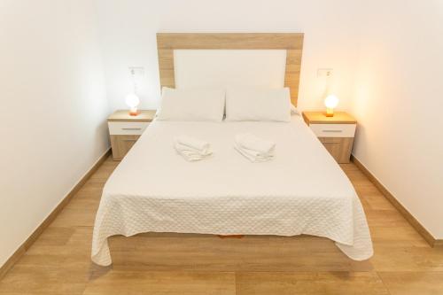 מיטה או מיטות בחדר ב-Casa Camarinero - Reformado