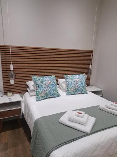two beds in a hotel room with towels on them at The Stetson in Paarl
