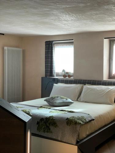 a bedroom with a large bed with a window at La Rêverie de Thumel - Suite in Rhêmes-Notre-Dame