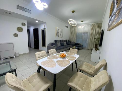 a living room with a white table and chairs at Luxury 2BR with balcony in the heart of Dubai Marina, The Belvedere Happy Home in Dubai