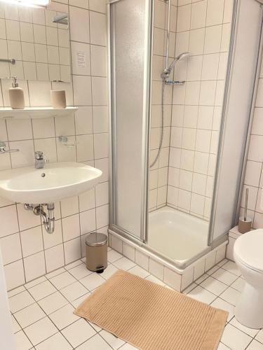 a bathroom with a shower and a sink and a toilet at MY HOME Apart, kitchen, WIFI in Chemnitz