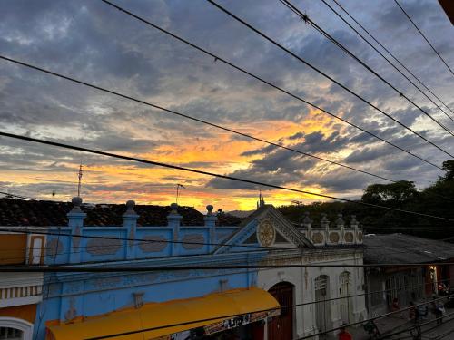 a view of a building with a sunset in the background at Casa Hotel Los Fundadores in La Victoria