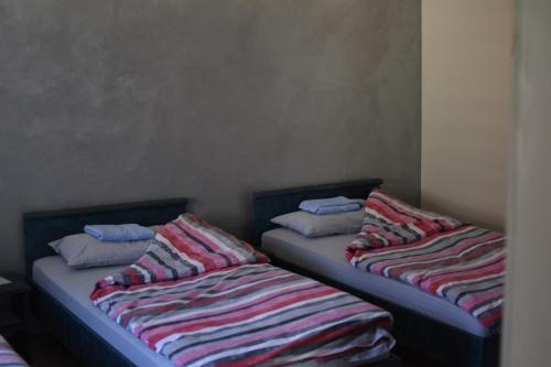dos camas sentadas una al lado de la otra en una habitación en Konak Garavi sokak, en Kuršumlija