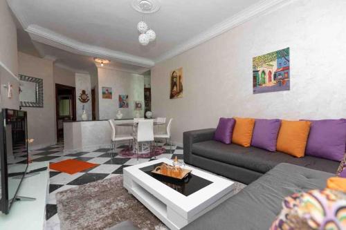 a living room with a couch and a table at Appartement Tetouan Saniat Ramel Airport Plage Martil WIFI in Tetouan