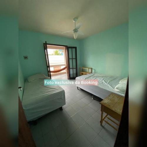a bedroom with a bed and a table in it at casa de praia ibicui in Mangaratiba