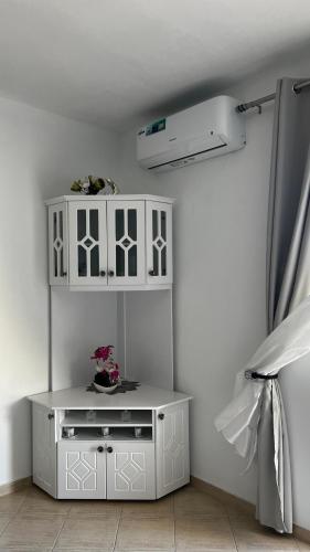 a white cabinet in the corner of a room at Sea View Apartments in Sarandë