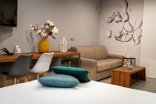 a living room with a bed and a couch and a table at B&B Rakel Home in Milazzo