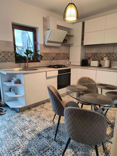 a kitchen with four chairs and a table in it at A&A Apartment in Iaşi