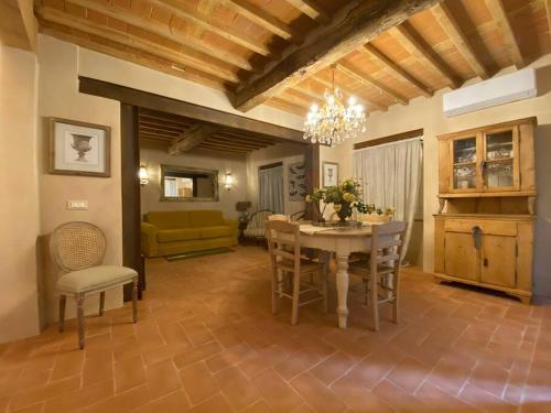 een woonkamer met een tafel en stoelen en een bank bij Casa Bartoli - Panoramic House Buggiano Castello in Borgo a Buggiano