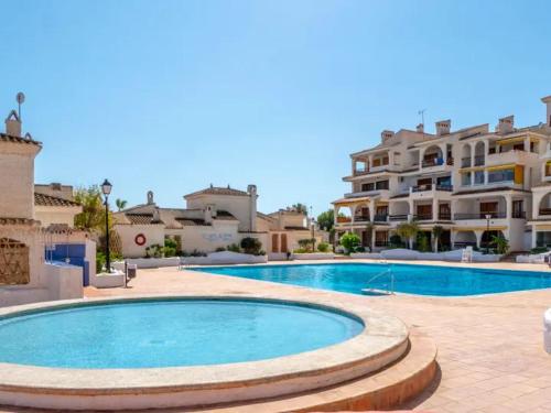 a large swimming pool in front of a building at BRISAS VARADERO in Santa Pola