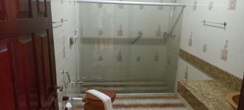 a bathroom with a shower and a toilet in it at Victor's Center Hotel in Guarabira