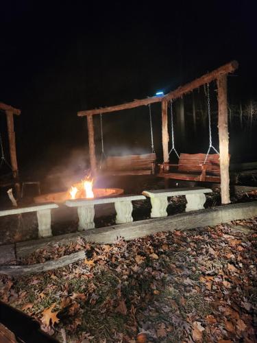 a fire pit in the dark with a fire at Serenity Hill bed and Breakfast in Brownsville