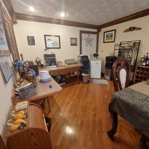 a living room with a desk and a table at Serenity Hill bed and Breakfast in Brownsville