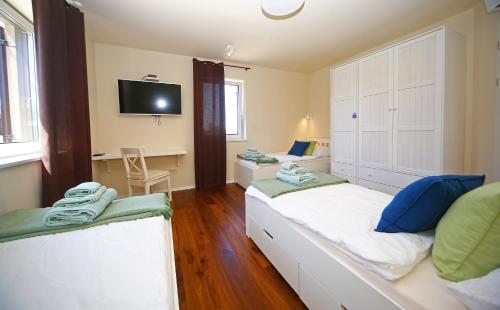 a small room with two beds and a tv at Luxury Villa Gradin in Gračišče
