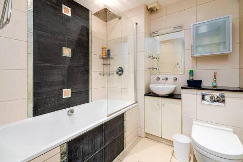 a bathroom with a shower and a toilet and a sink at 2BR flat next to London Eye on lower marsh 96A in London