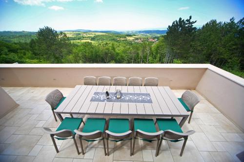 a table and chairs on a balcony with a view at Luxury Villa Gradin in Gračišče