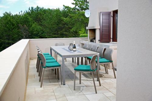 a patio with a table and chairs on a balcony at Luxury Villa Gradin in Gračišče