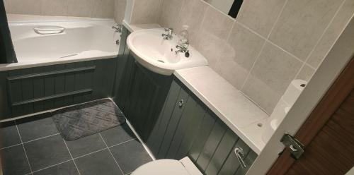 a small bathroom with a sink and a toilet at Penzance Cottage in Penzance