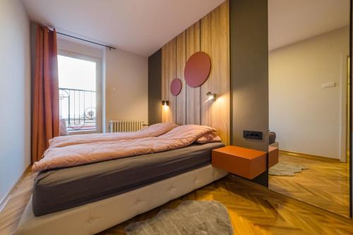 a bedroom with a large bed and a window at Apartman Nika in Pirot