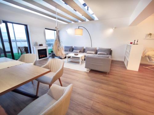 a living room with a couch and a table at Penthouse View 29 in Piteşti