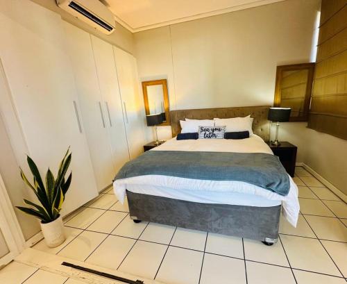 a bedroom with a large bed in a room at The Waves 905 Quayside Point in Durban