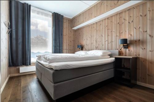 a bedroom with a large bed and a window at Hemsedal - Fyri Resort - Leiligheter in Hemsedal