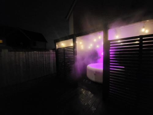 a bathroom with a bath tub with purple lights at LUXE INN, Birmingham Airport & NEC, FREE Parking in Marston Green