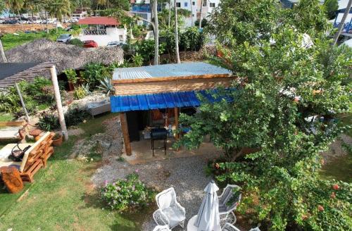 an aerial view of a house with a blue roof at Arena Oceanview Hotel & La Terraza Restaurant in Las Galeras
