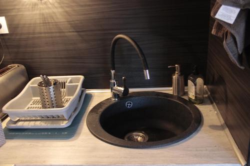 a sink in a bathroom with a sink at Villa dans la Pinède in Cap d'Agde
