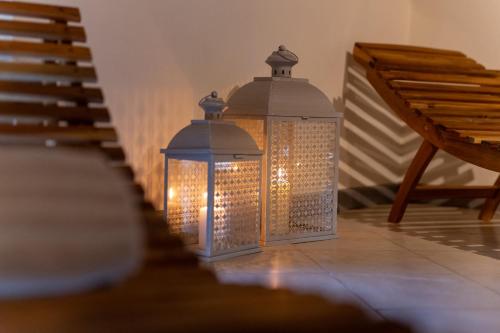 two glass lanterns sitting on the floor next to stairs at Villa Romantica Wellness & SPA in Lucca