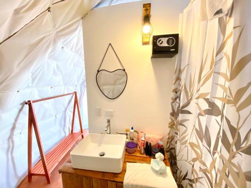 a bathroom with a sink in a tent at Arena Oceanview Hotel & La Terraza Restaurant in Las Galeras