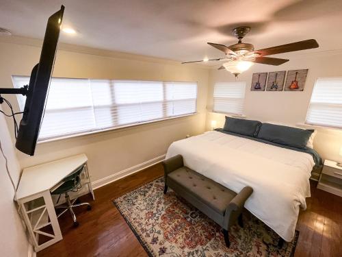 a bedroom with a bed and a ceiling fan at Quiet home 15min from FQ, 10min from Trendy Bywater Neighborhood in Arabi