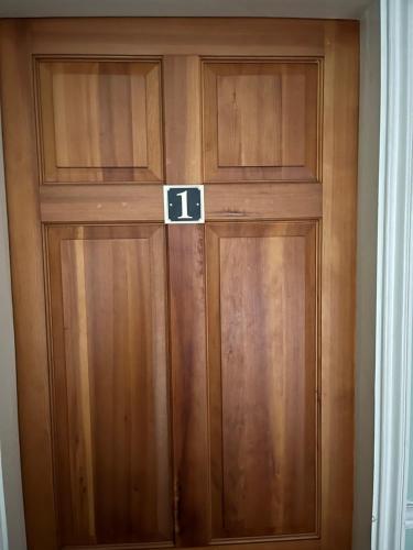 a wooden door with the number on it at Unwind in comfort at cosy Caradus your 8 bed Home Sweet Home! in Birmingham