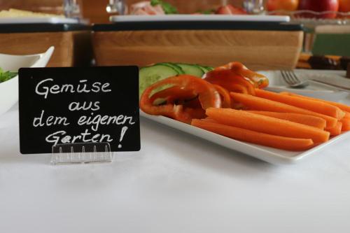 a plate of carrots and pretzels next to a sign at Gasthof-Pension Schütz in Wesenufer