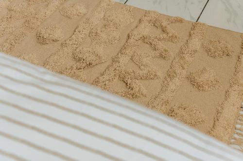a pile of sand written in the sand on a bed at Villa Marinia 3*: Charme Créole in Saint-Denis