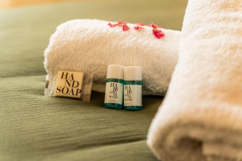 two bottles of hair no soap next to a towel at Villa Marinia 3*: Charme Créole in Saint-Denis