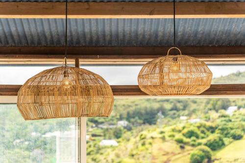 three rattan lights hanging from a window at Villa Marinia 3*: Charme Créole in Saint-Denis