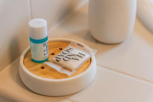 a bottle of lip balm sitting on top of a counter at Villa Marinia 3*: Charme Créole in Saint-Denis