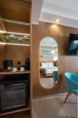a room with a bedroom with a bed and a mirror at Royal & Imperial Belvedere Resort in Hersonissos
