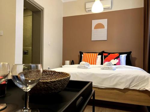 a bedroom with a bed and a table with a wine glass at ComeLiveGO Cihangir 12 in Istanbul