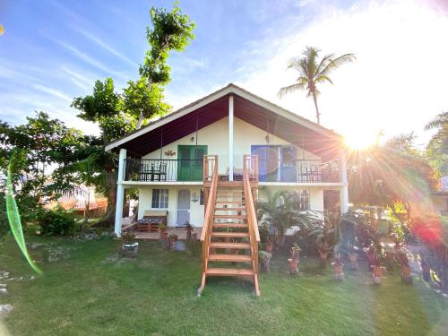 a house with a ladder in front of it at Arena Oceanview Hotel & La Terraza Restaurant in Las Galeras